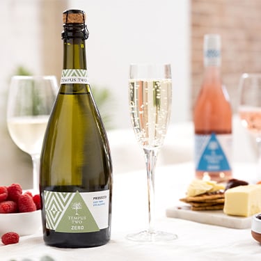Bottle of prosecco with other bottles of wine in the back ground