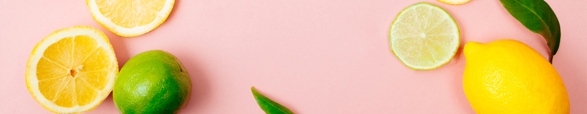 Lemon and lime coktail ingredients pink background