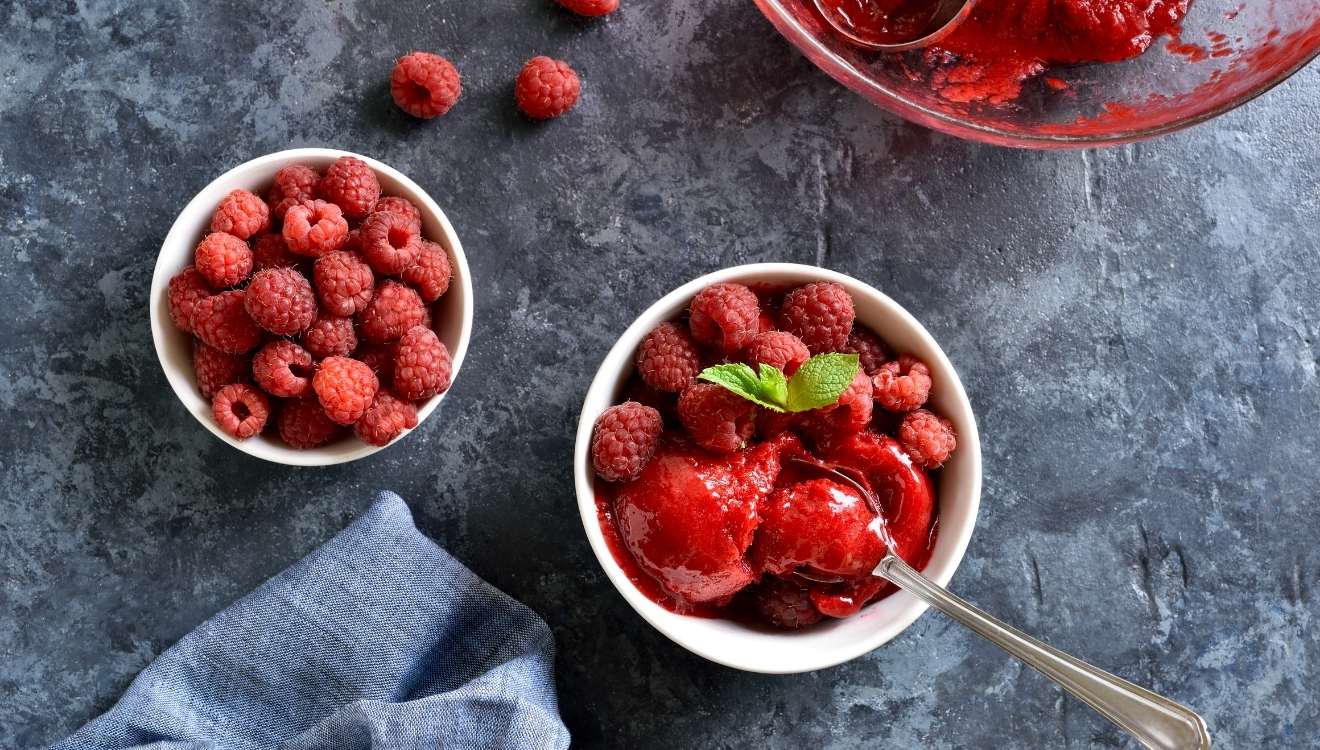 bowl of Raspberries with a bowl of vegan raspberry sorbet