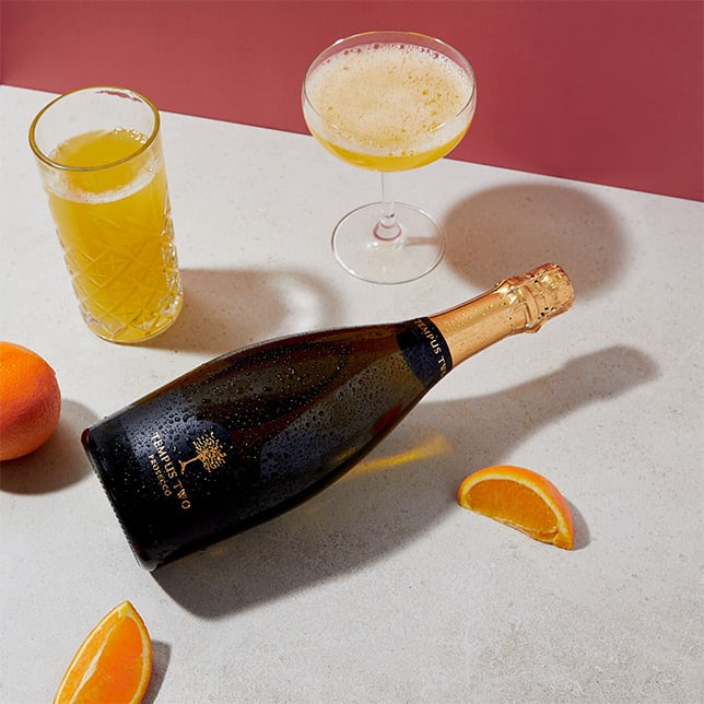 Tempus Teo Varietal Prosecco with Bellini cocktail and orange slices