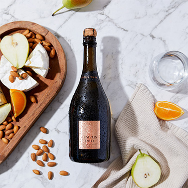 Tempus Two Copper Prosecco flatlay with pear and cheeseeplatter