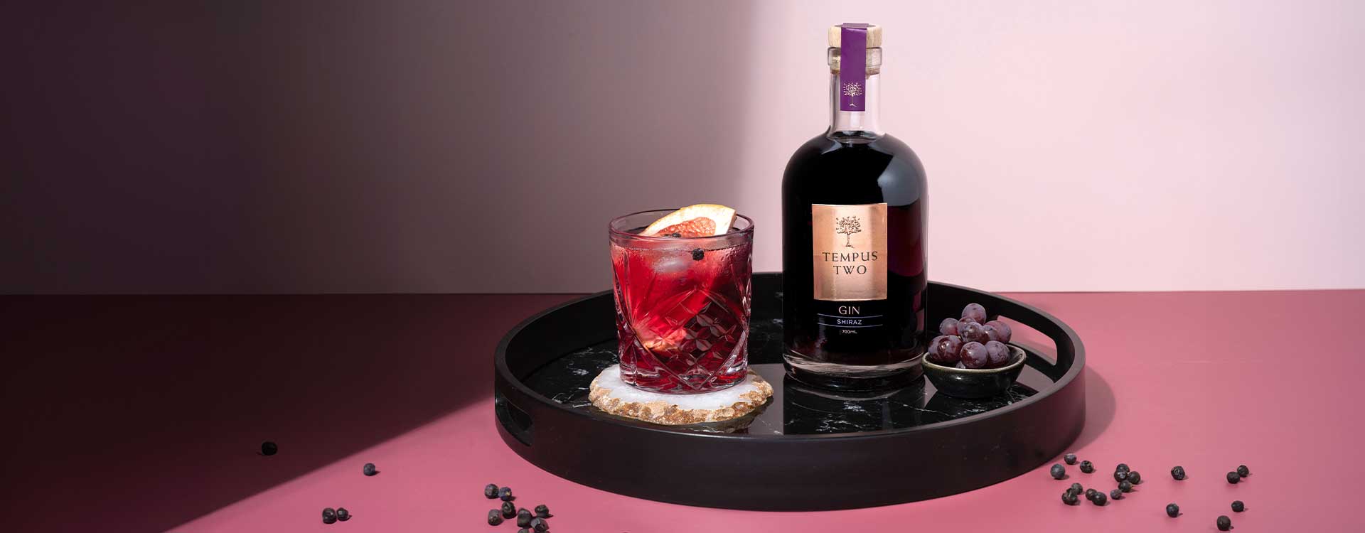 Tempus Two Lighten Up Rose bottle and glass on a table outdoors