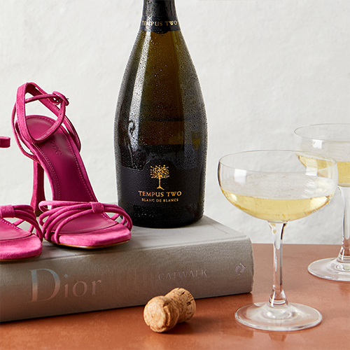 Tempus Two Varietal Sparkling bottle with Dior magazine and pink heels