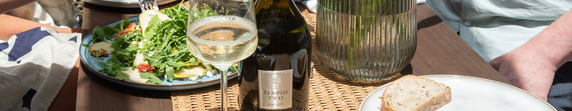 Women cheers-ing glasses of Semillon wine in Tempus glasses